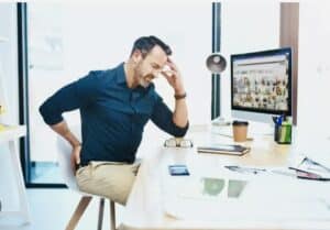 back pain due to poor posture at workstation