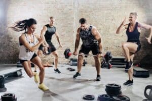 People performing high-intensity interval training, running at a fast pace  with a focused expression, showcasing the intensity of the workout.